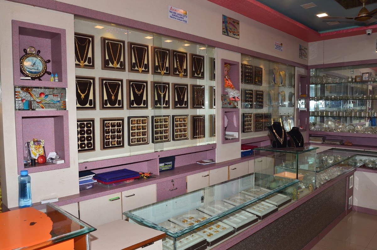 Interior of Sri Vasavi Jewellers showroom in Vuyyuru, with gold jewellery displays